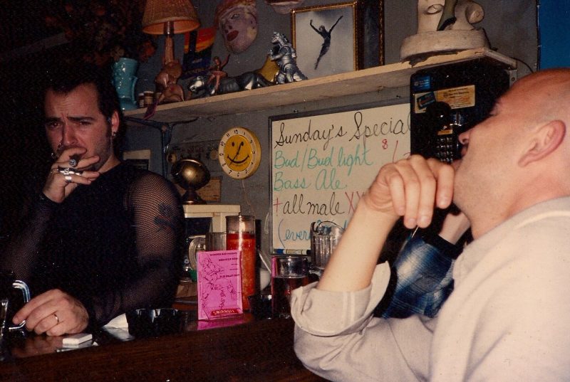 Me, bartending @ Wonderbar, NYC, in early 1990's, smoking a cigar. Mesh top designed by Judy DeBoer. Notice the all Night XXX Porn advertising. Good Times.