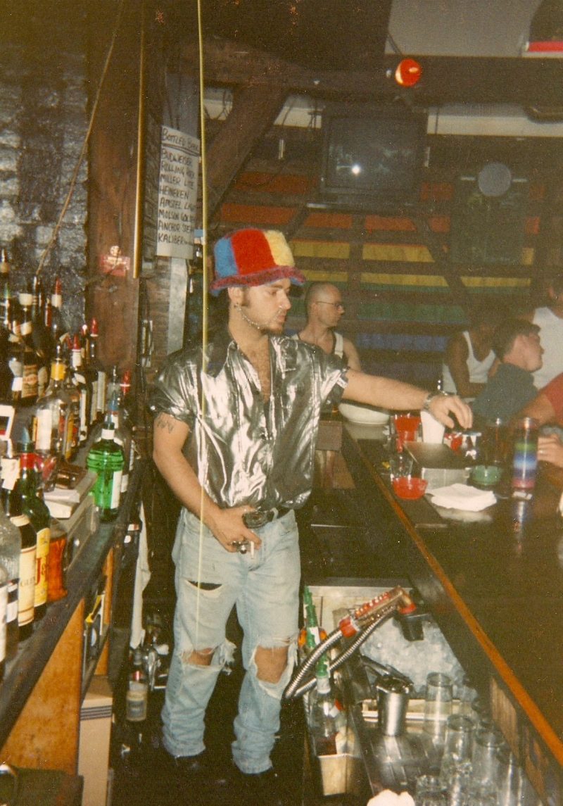 Me, bartending @ Wonderbar, NYC, in 1994, wearing Jamiroquai hat, custom made silver shirt, Harley Davidson belt buckle & Jean Paul Gaulthier rip/off nose ring with chain. Nuff said. Photo by my Mom.
