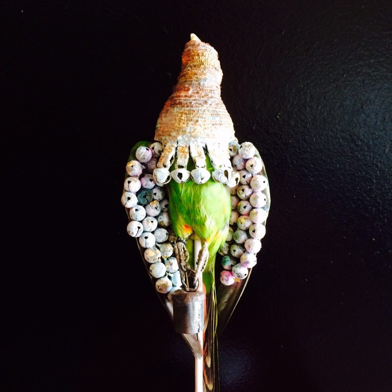 Rowan Corkill (London, England), Vigilant Things (Lovebird), 2015, Taxidermy Lovebirds. Brass bells. Ammonia. Bicarbonate. Imitation gold leaf. Rope. Padlocks. White Wood Base. $625. (Detail)