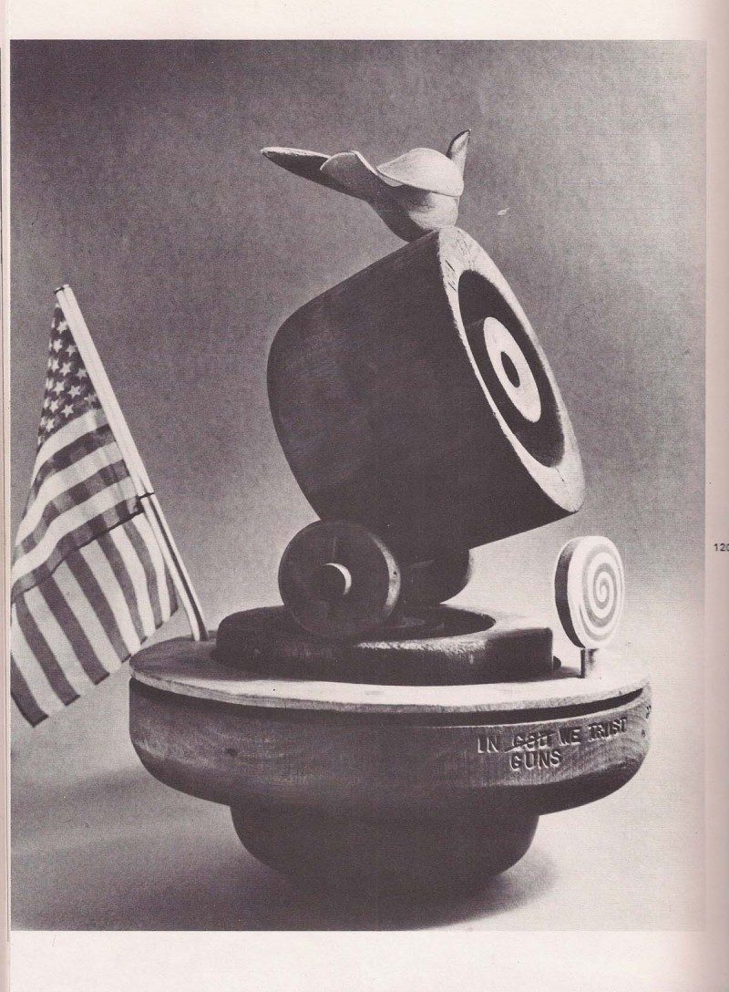 Original Image from 1970's catalogue. 'In Guns We Trust' Rare Sculpture by Arthur Price, 'Good Ship Lollipop' aka 'In God (crossed out) Guns We Trust' 1972, Arthur ‘Art’ Price, Found Wood Antique Hat Forms & Bird Sculpture in Aluminum & Polychrome (made by the artist), Found American Dime 1960’s, Spiral Wood Lollipop sculpture (made by the artist), 17 height x 10.5 width x 17 depth (with metal rod) inches. One of a kind sculpture. Titles & artist named stamped / see original photos from 1970’s catalogue of the artist’s artworks entitled 'Art Price. Happiness Is Where You Find It. Volume 2'. Price available upon request (current appraisal underway)
