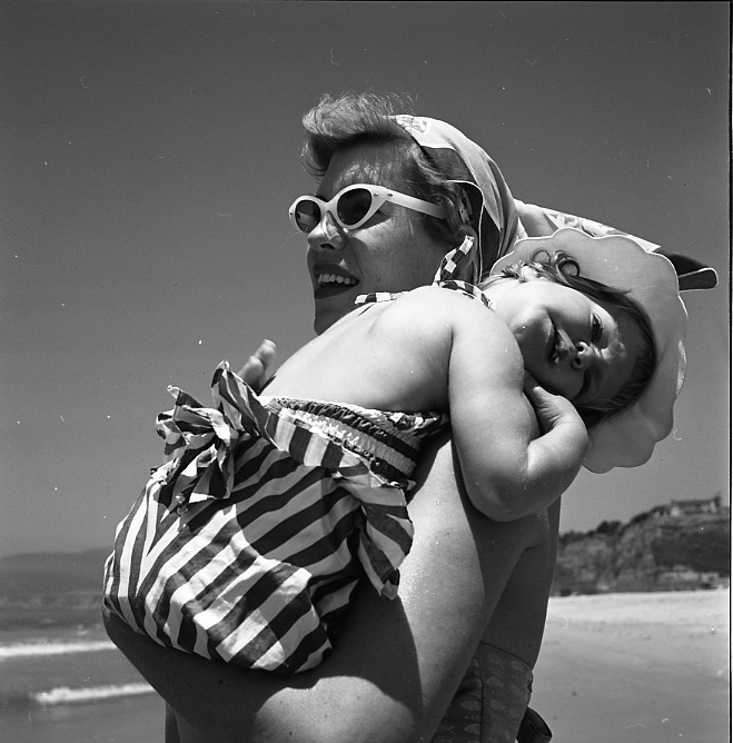 Vivian Maier, California, Woman Holding Young Girl at Beach. 1955.