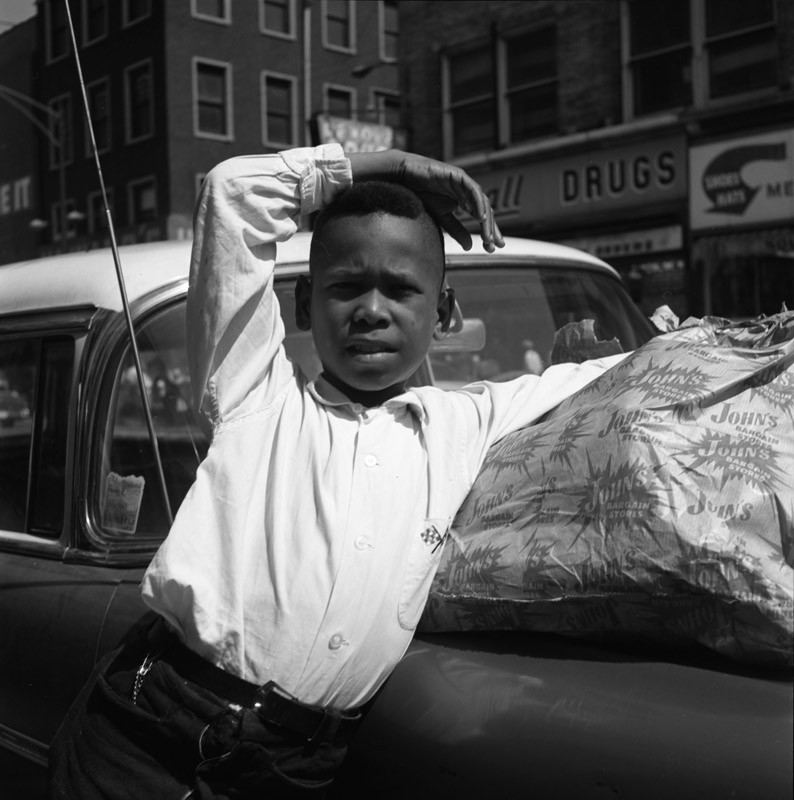 Vivian Maier, Chicago Maxwell St., Young Man with Arm Over Head. 1967.