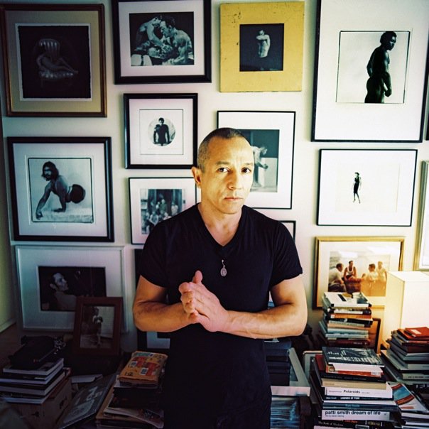 Portrait of Michael Alago at his home, with his collection of photographs.