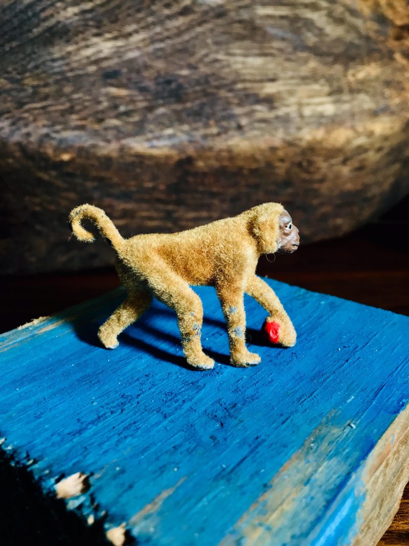 Antique Metal Monkey with Red Ball. Toy is covered in fake fur texture (possibly felt). Measures 2 inches length x 1.5 inches height. SOLD.