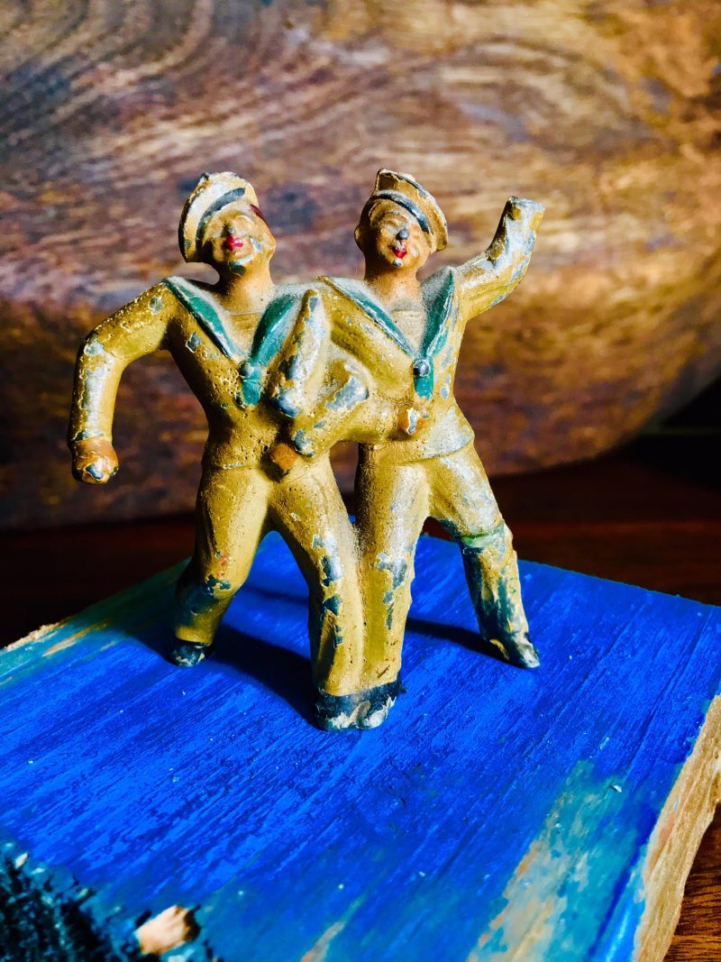 Antique Pair of 'Drunken' Sailors, or they are secretly lovers. Made of metal, 1920's. One leg seems to have been soldered or glued ages ago, perhaps from a drunken fall. $25.
