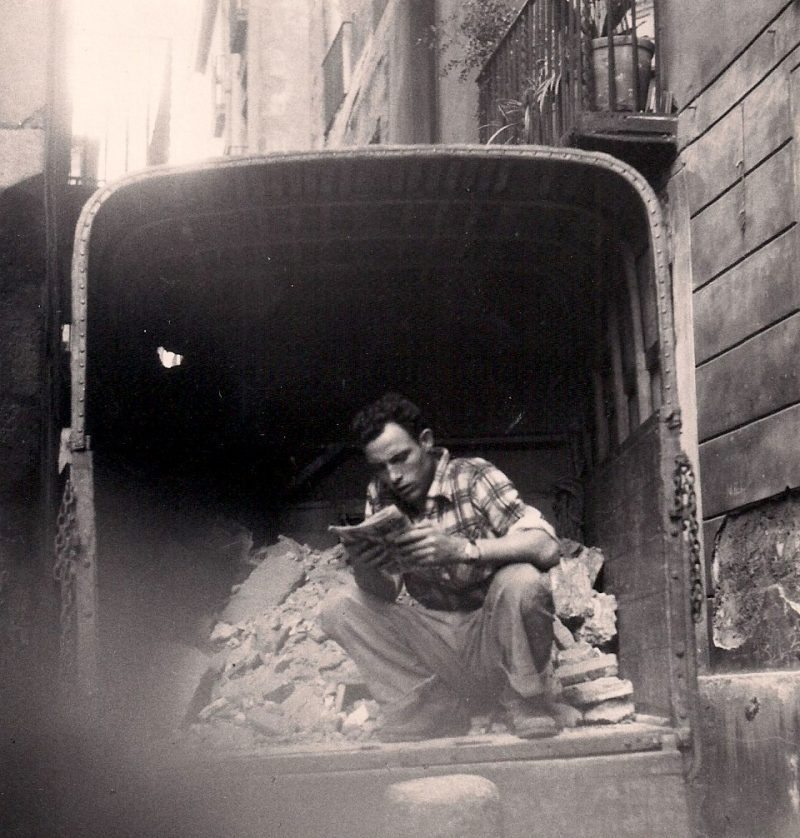 Jerome Hill, Barcelona, 1957. Siver Gelatin Photograph, 5 x 5.25 inches. Part of a Set of Prints. Man Reading in Truck: USD$250