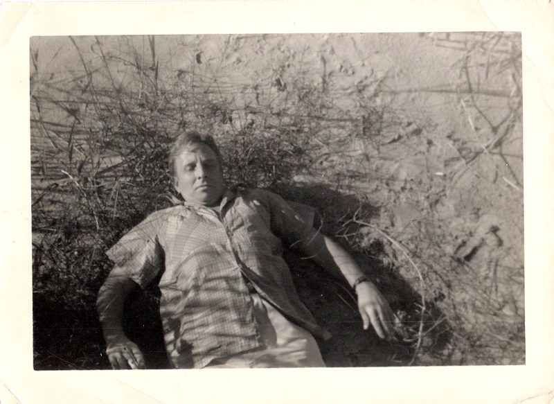 Mid Century Vintage Authentic Photograph, 'Man Lounging Awkwardly in Beach Grass', Measures 4.5 x 3.25 inches. SOLD.