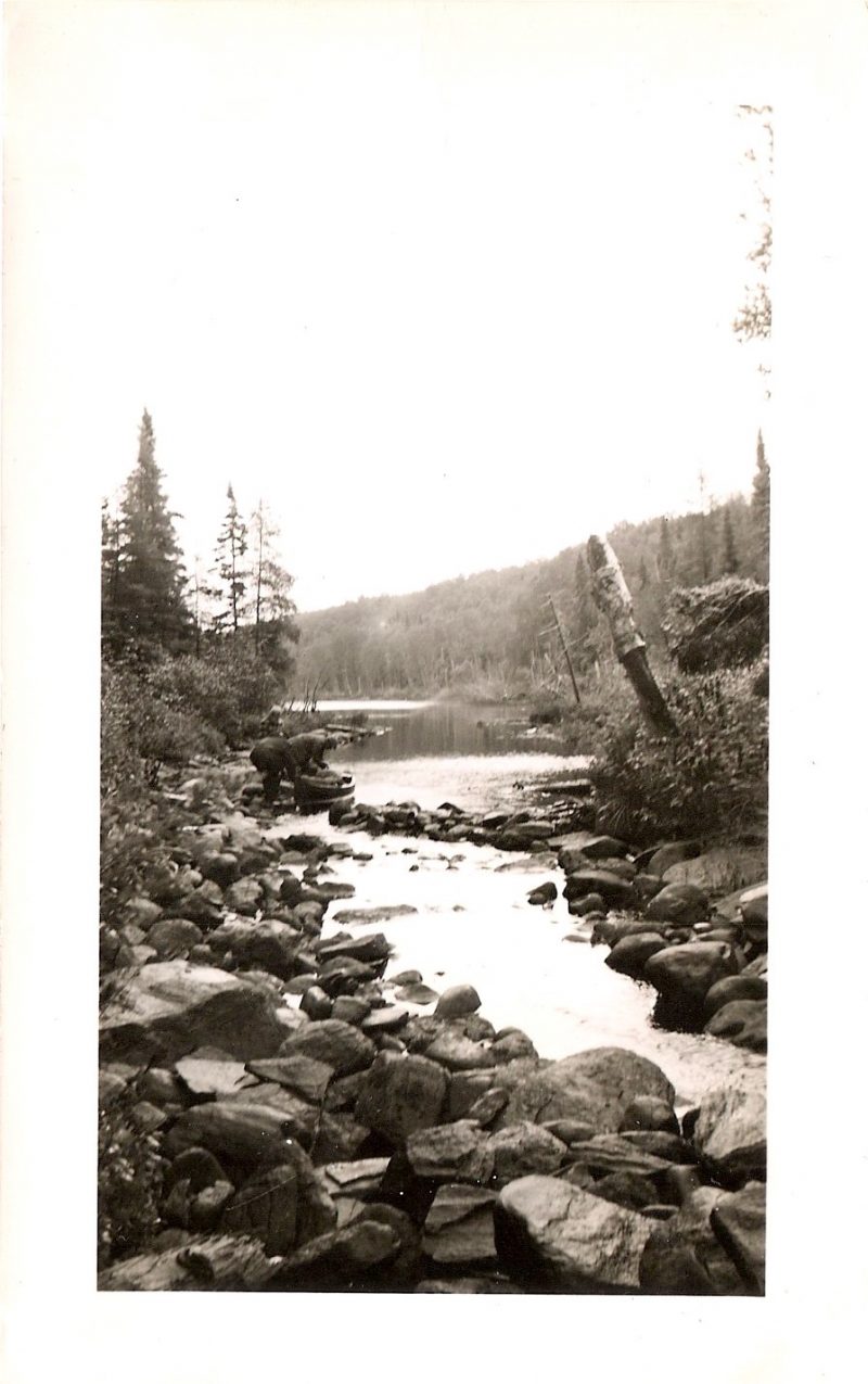 Vintage Anonymous Photograph, 'Two Men & Canoe by the River', Handwritten 'Sept 1950', Measures 3 x 4.75 inches. SOLD.