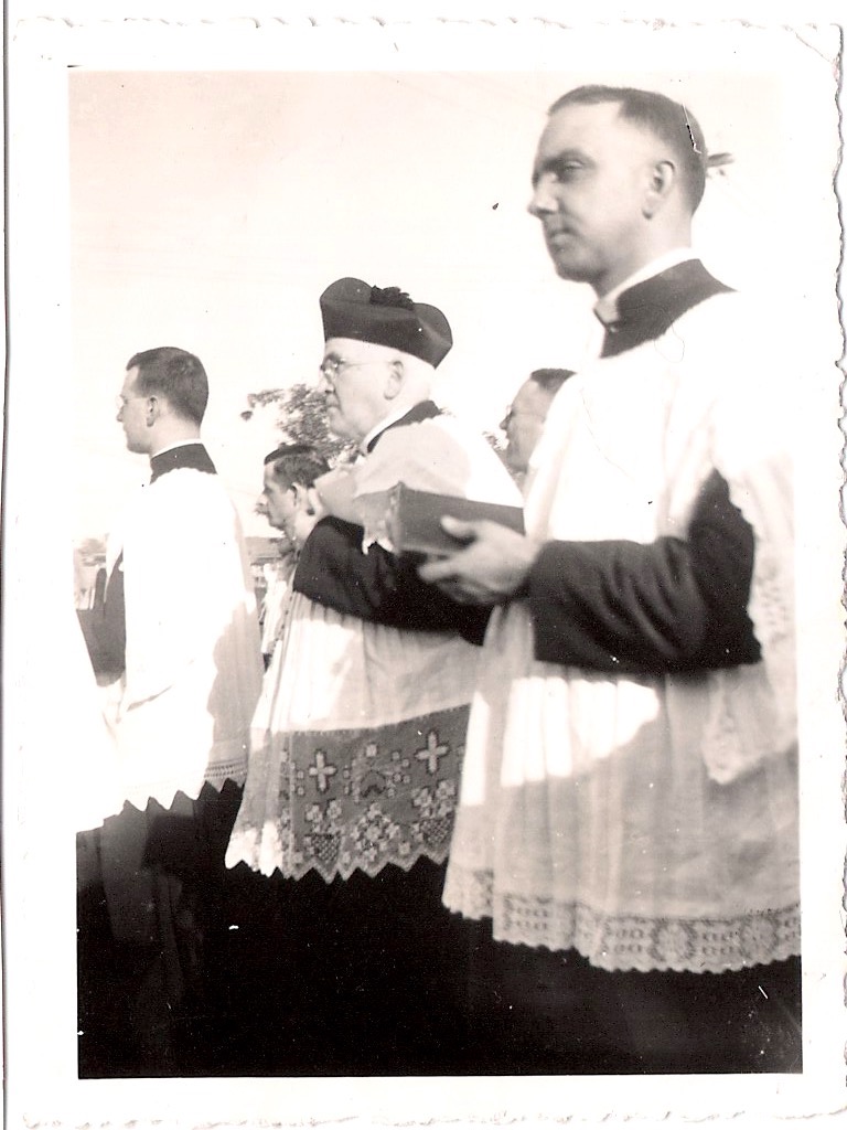 Vintage Anonymous Photograph, 'Young Priest Giving some Serious Side-Eye during Ceremonial Procession', Ink Stamped on verso; 'A. Grodin, 294 St. Georges, Trois-Rivieres', 1950's, Measures 2.5 x 3.5 inches. $45