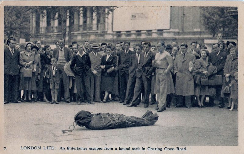 Vintage Postcard, 'London Life: An Entertainer Escapes from a Bound Sack in Charing Cross Road', Measures 5.5 x 3.5 inches, Approx. 1950-60's, Hand writing on verso dated March 28, 1971. $25. (Card has been reused from a previous messge written in 1965. From a Series of Postcards of London Life in 1950 by Charles Skilton.   http://www.peterberthoud.co.uk/blog/19012018091114-postcards-of-london-life-in-1950-by-charles-skilton/