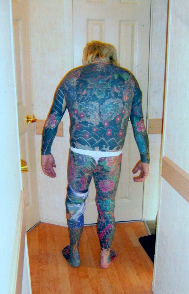 'Insanely Fabulous & Heavily Tattooed Man with Rod Stewart Hairdo, Lots of Bling & Prosthetic Leg which is Painted to Match his Tattoos. Set of 3 Spectacular Digital Photographs. Printed on Fujifilm Photo Paper, Measure 4 x 6 incehs each. $85 set.
