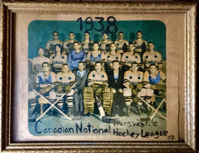 Jay Bosse (Ottawa, Canada), “Canadian National Transvestite Hockey League 1938”. Unusual & unique artwork created by unknown artist / see initals ‘J.B.’ signed on lower right. Watercolor added to a vintage photograph of hockey player league. s width x 10 inches height with vintage wooden gold colored frame. $125.