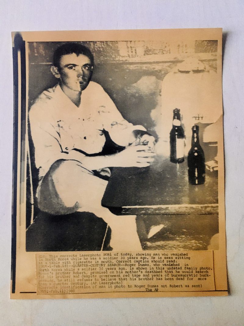 Portrait of Missing Man, Photograph aged in sepia tone. Measures 6.75 x 8.45 inches. Text is long but briefly; 'Man named Roger Dumas, who vanished in North Korea while he was a soldier 30 years ago. Photo dated 1980. $25.