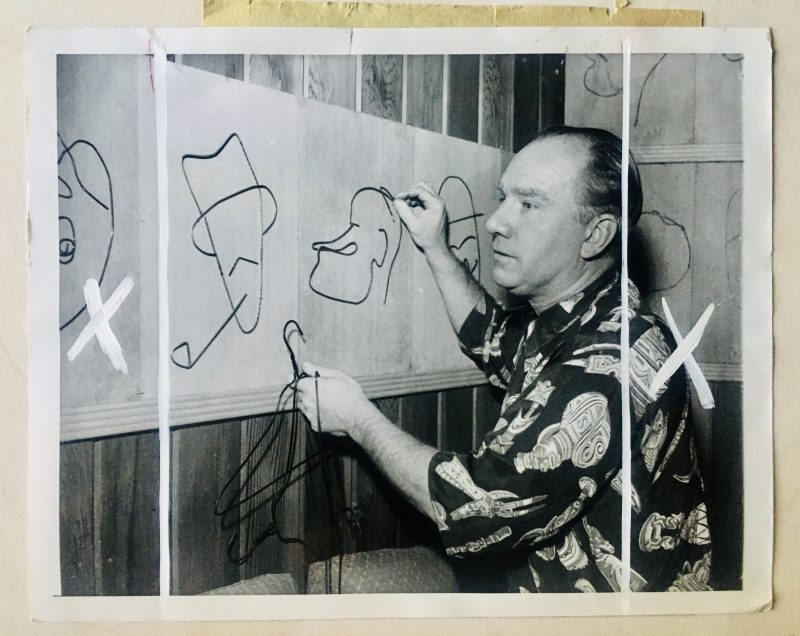 Vintage Authentic Press Photograph, includes newspaper clipping attached to the verso: 'Wide World Photo. 'Wired for Sight'. Frank Dunn, an artist of North Hollywood, Calif. works on a caricature of Bob Hope made from wire coat hangers. At left is Bing Crosby. (more text to follow). Dated 3/20/54. SOLD.