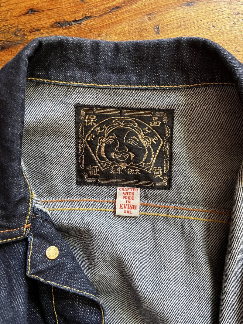 EVISU Jean Jacket. Unisex Hand Painted. Label: 'Crafted with Pride in EVISU XXL'. One outer pocket / no inner pocket. Button fastening, 4 pockets. 100% Cotton. EVISU Premium Quality Kamon tag. Mint condition. $300.