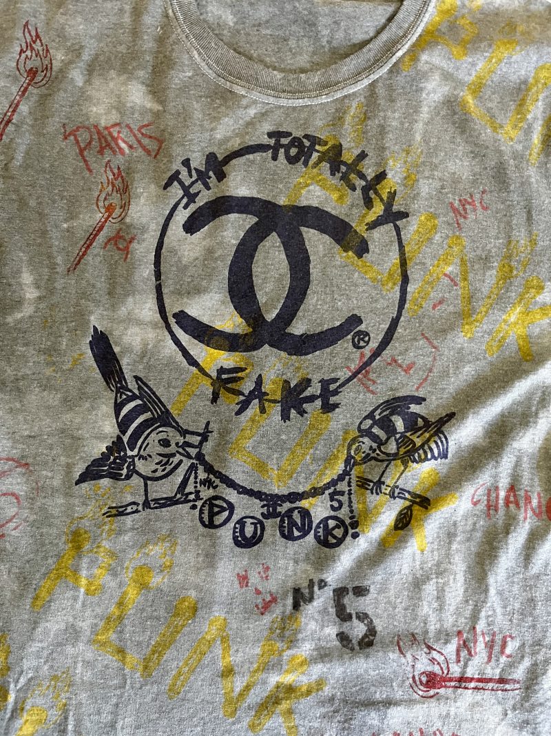 SCOOTER LAFORGE TSHIRT #3, 'FAKE CHANEL', Large Men (Unisex), Hand Painted & Printed & Dyed Cotton Grey T-shirt with Custom Hand-Stitched Label with 'Bear & Hearts': Classic trademarks  from the earlier years. Notice 'Paris is Burning' reference. USD$200. 